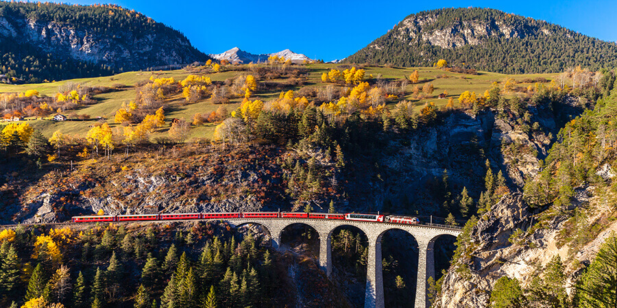 Train on viaduct in swiss alps