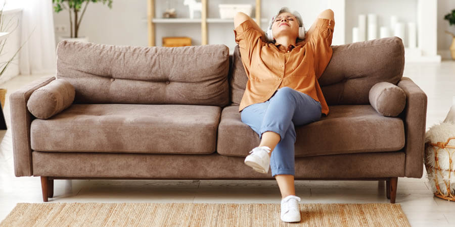 Woman listening to music on couch